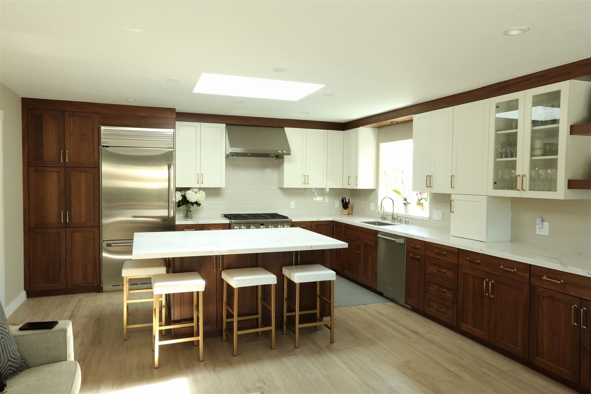 A Wood Themed Cabinets With White Counters