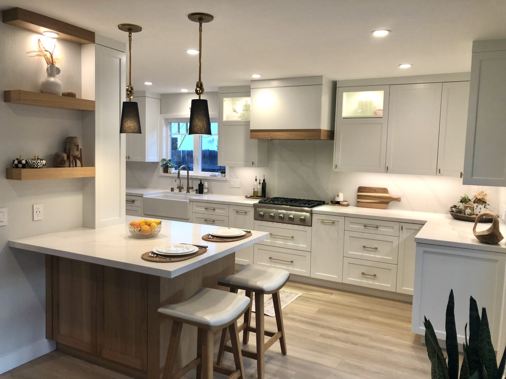 A Kitchen Island With Two Ceiling Lights