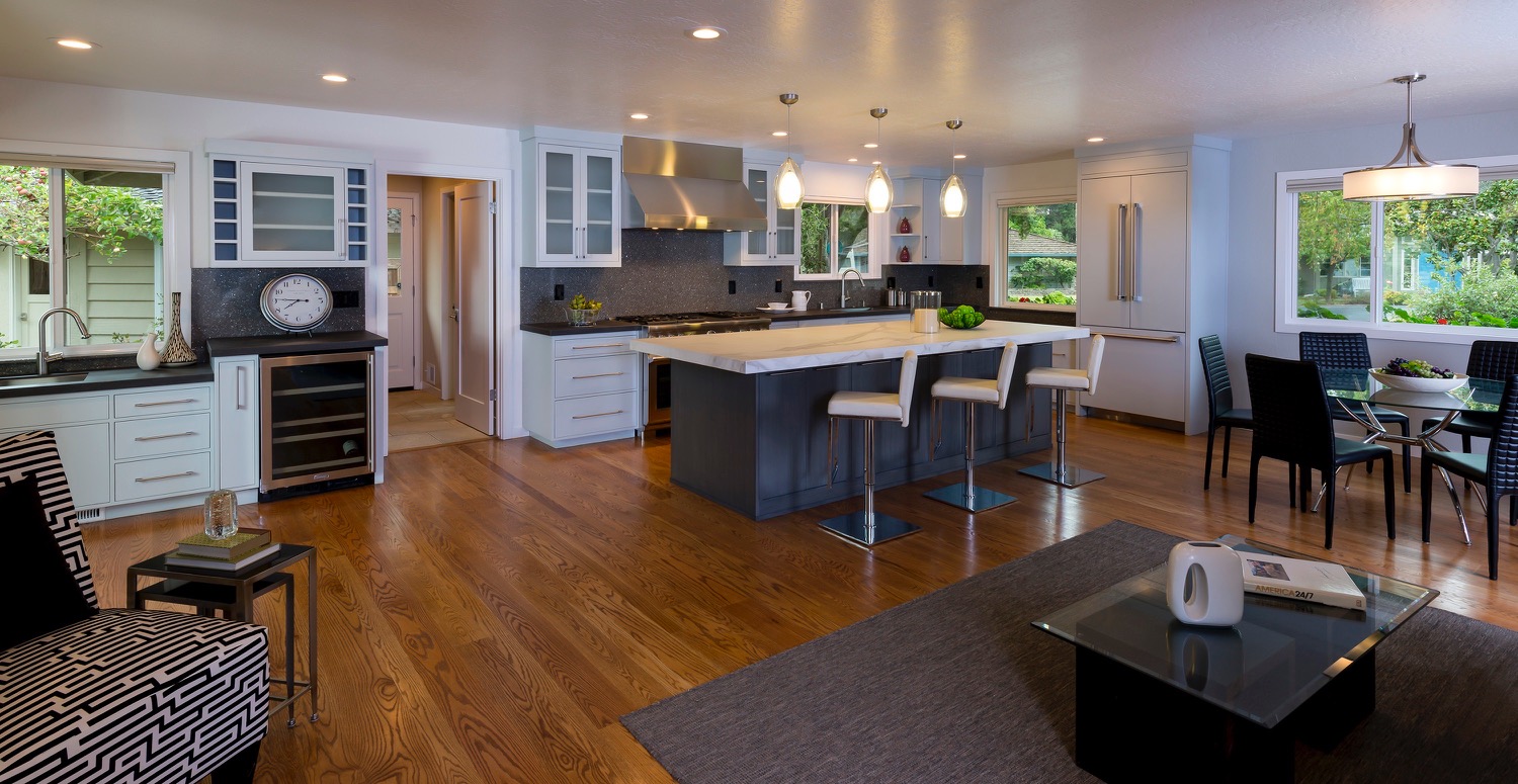 A Kitchen Island With Revolving Bar Chairs