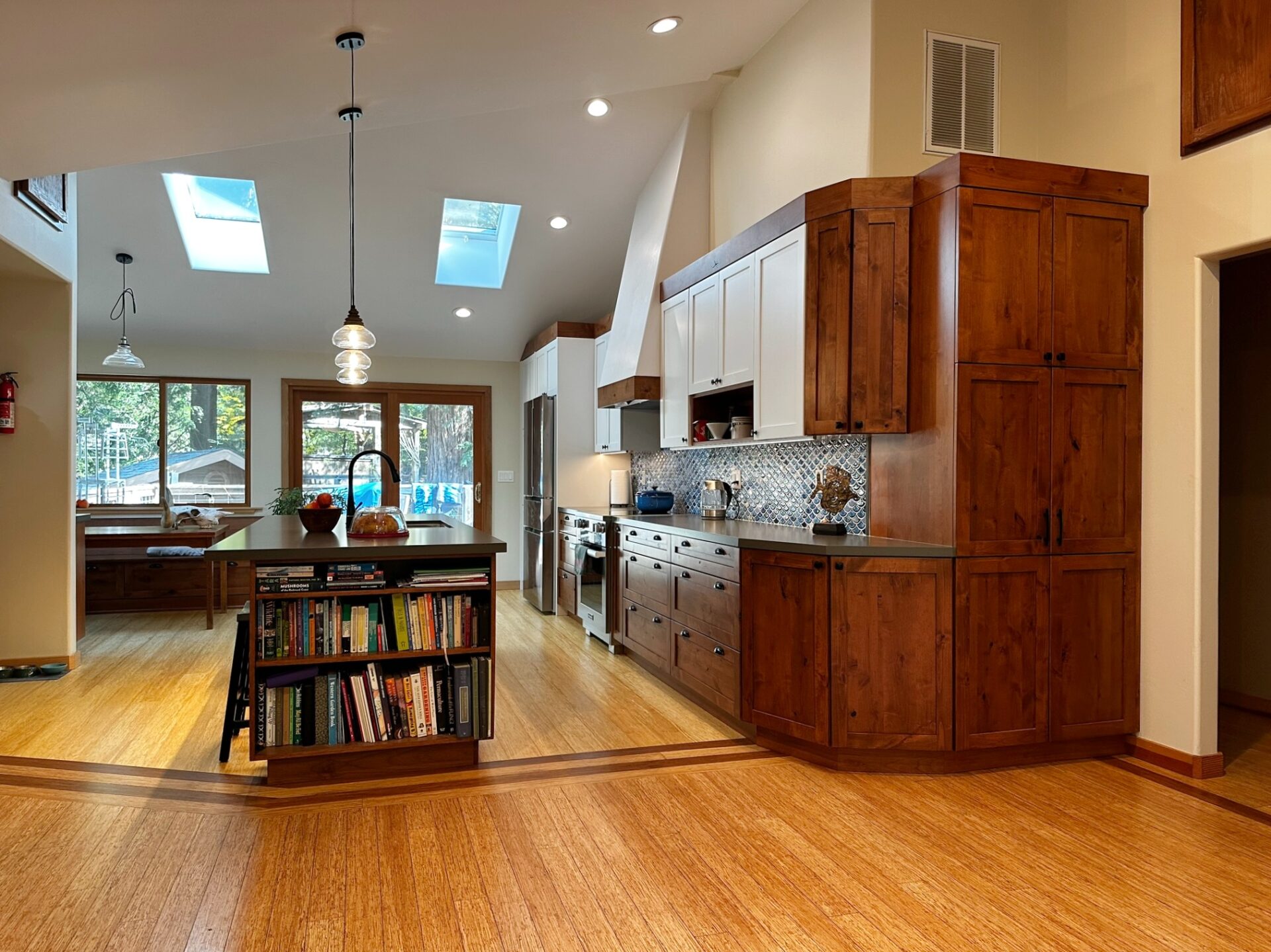 A Kitchen Island With a Book Shelf on Side