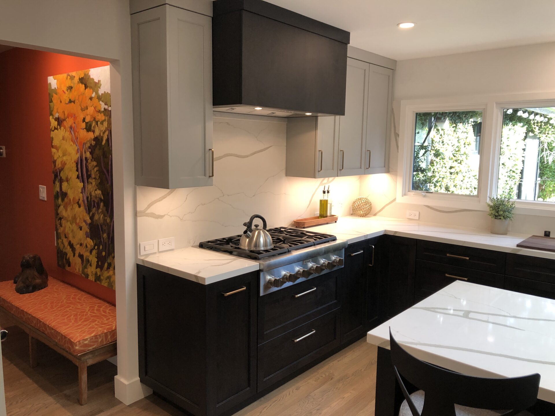 A Grey and Black Color Kitchen With Marble Countertop