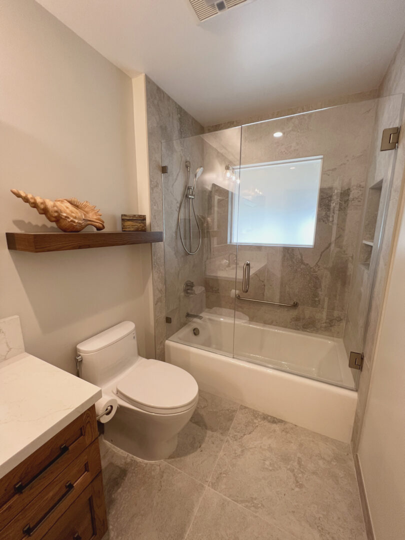 A Tub Space With Glass Doors for Closure