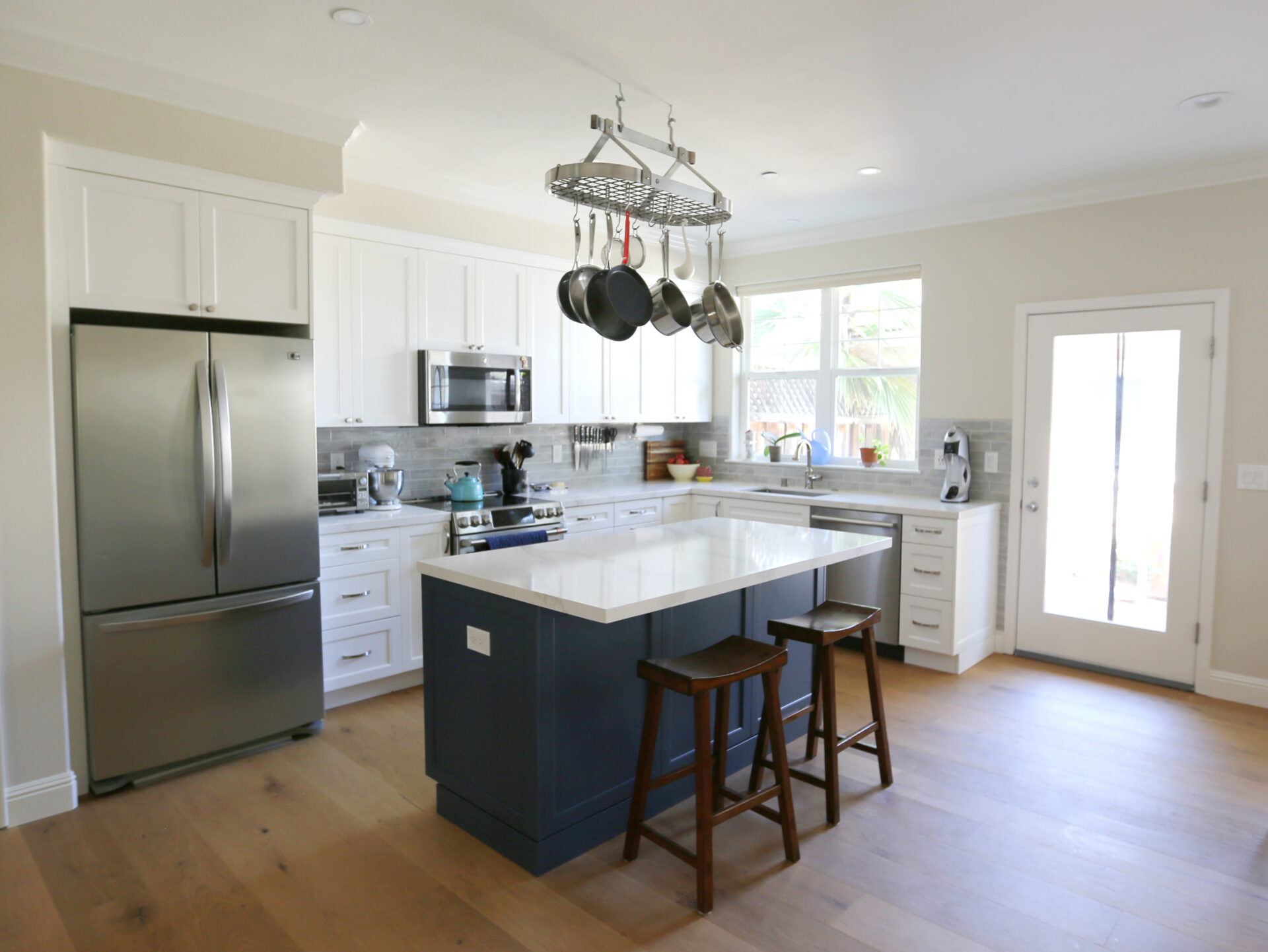 A Kitchen Island With Navy Blue Door Space