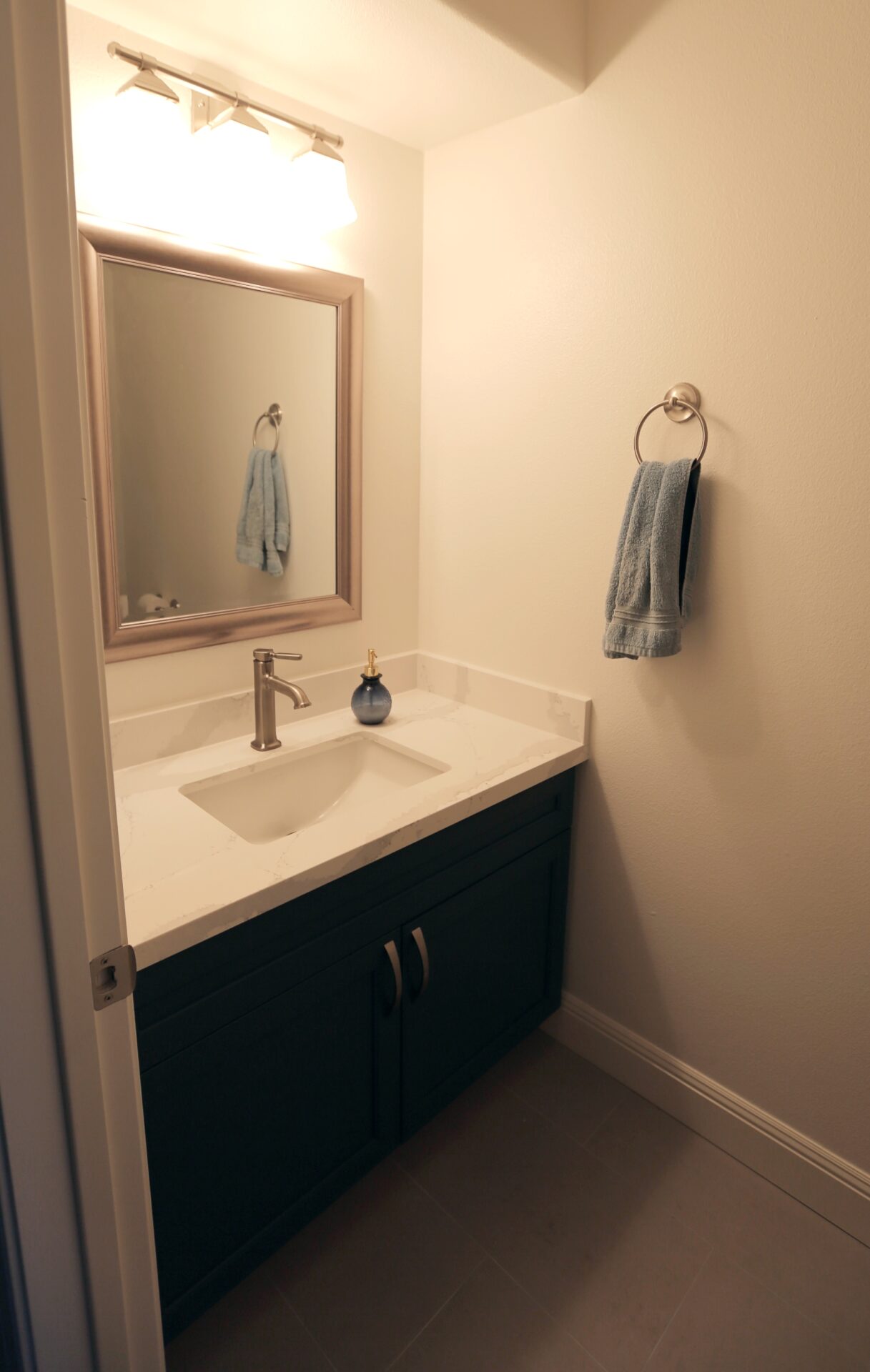 A White Color Sink Cabinet With a Tap