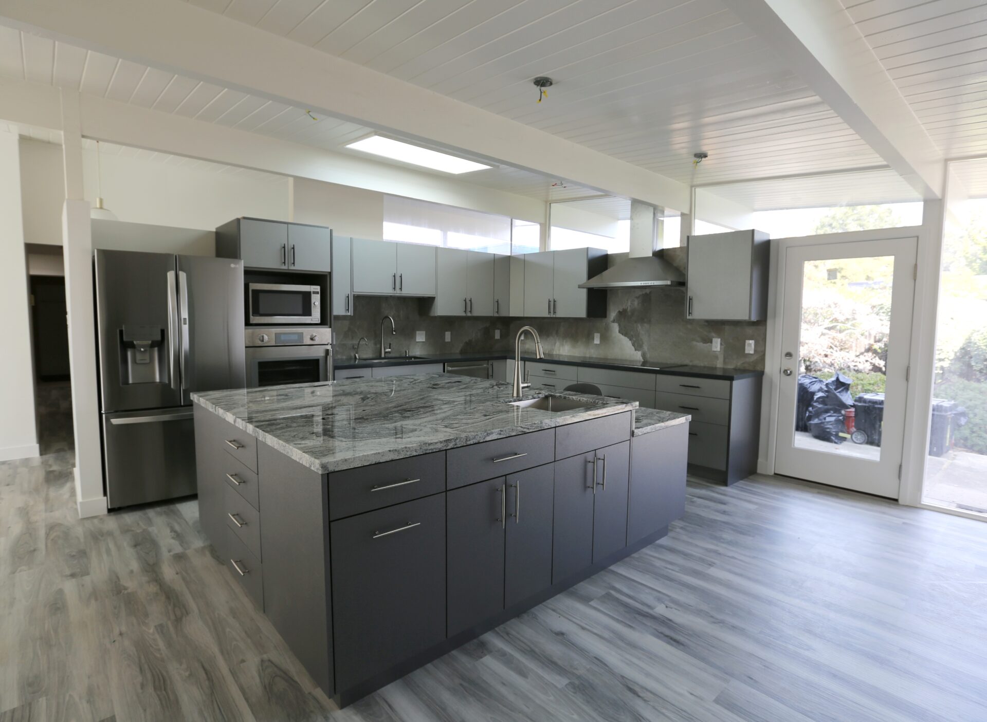 A Black Color Kitchen Cabinets With a Sink